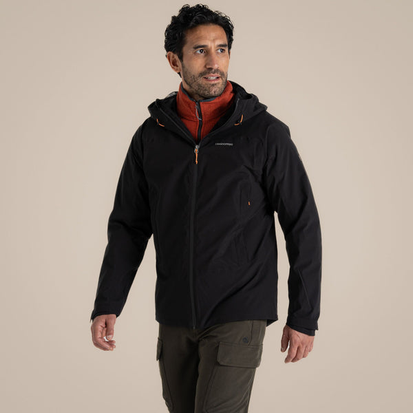 Man wearing Craghoppers Ponsa stretch AquaDry waterproof trail jacket  equipped with hood and storm flap