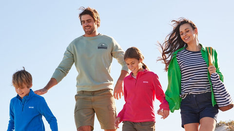 Family dressed in Regatta Outdoor Clothing head to the beach