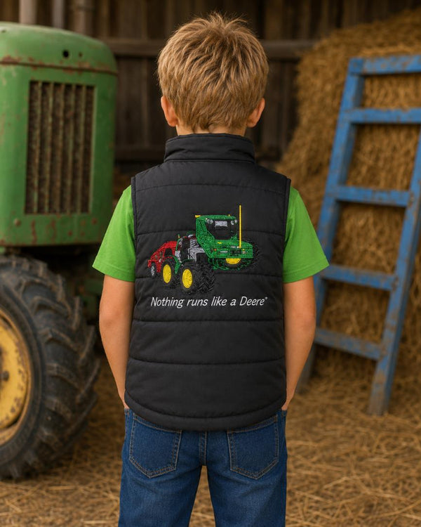 Back view of a boys black farm gilet with green tractor embroidery and a green T-shirt.