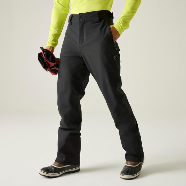 Model wearing black Dare2b Achieve III men’s ski trousers, front view
