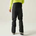 Model wearing black Dare2b Achieve III ski pants, rear view
