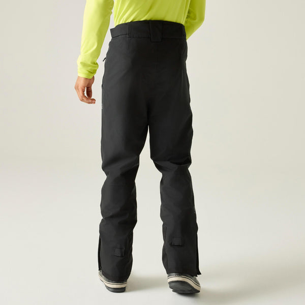 Model wearing black Dare2b Achieve III ski pants, rear view

