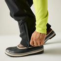 Close-up of the zipped hem gusset on Dare2b Achieve III black ski trousers over winter boots

