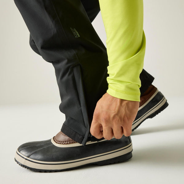 Close-up of the zipped hem gusset on Dare2b Achieve III black ski trousers over winter boots

