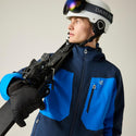 Dare2b Eagle IV Athletic men’s ski jacket worn with helmet and skis
