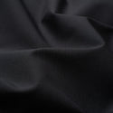 A close-up of draped black fabric with soft folds and a smooth matte texture.