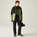 Full-length model wearing Dare2b Halfpipe IV Olive ski jacket with black ski trousers
