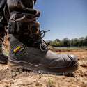 Side view of DeWalt Bedrock waterproof black safety boot being worn outdoors