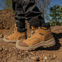 DeWalt Foundry Wheat waterproof safety boots worn on rocky outdoor ground