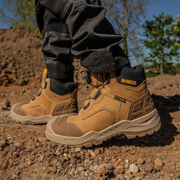 DeWalt Foundry Wheat waterproof safety boots worn on rocky outdoor ground