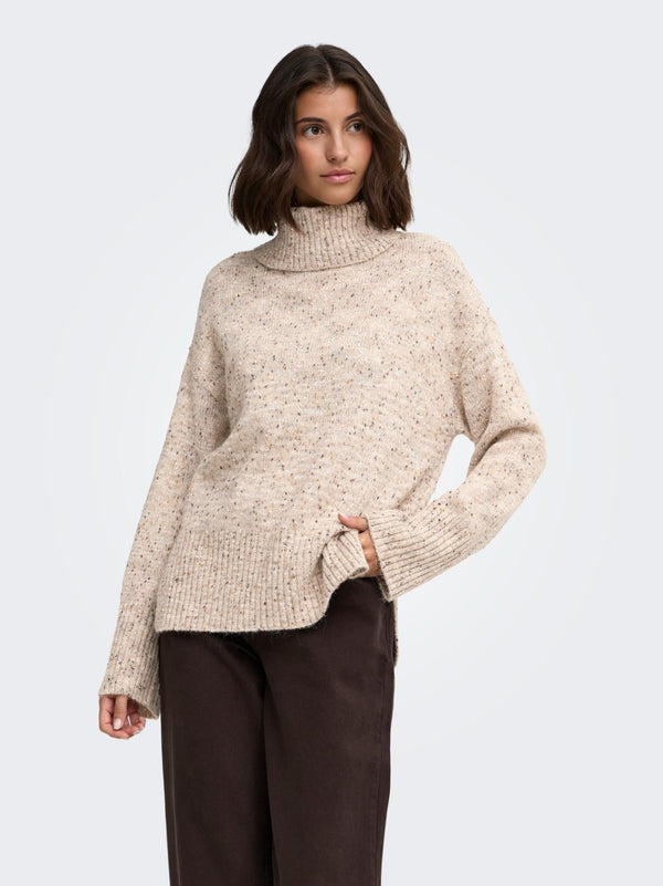 Model wearing JDY Sabine Oatmeal cowl neck knitted jumper with dark trousers
