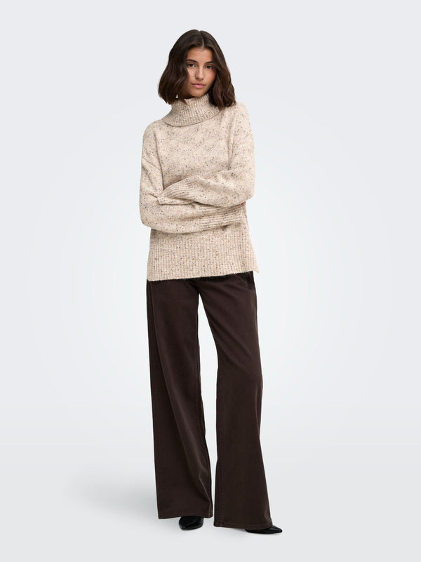 Model wearing JDY Sabine Oatmeal cowl neck knitted jumper with dark trousers
