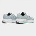 Pair of light blue running shoes with white soles on a white background