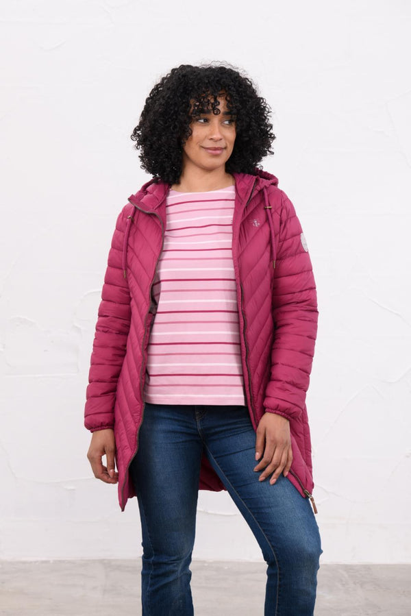 Woman wearing Lighthouse Laurel Berry coat open over a striped top