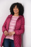 Woman wearing Lighthouse Laurel Berry coat open over striped top
