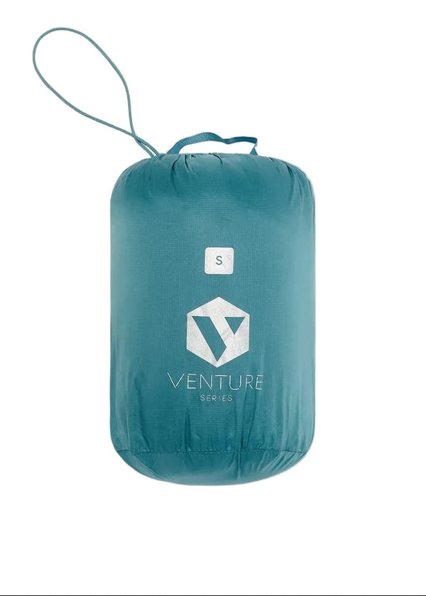 Mac in a Sac Nova women’s Atlantic Teal down jacket packed into its matching carry bag
