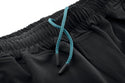 Close-up of black joggers with a blue drawstring on a white background