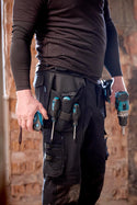 Workman wearing Makita Onyx stretch holster work trousers 