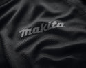 Close-up of Makita logo on a textured black fabric surface