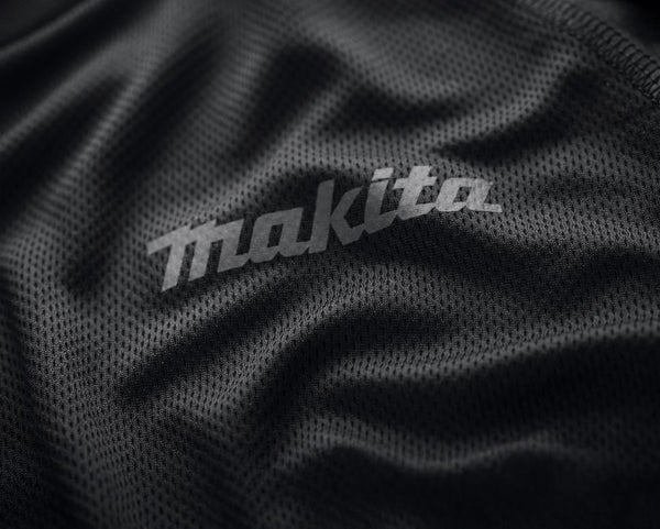 Close-up of Makita logo on a textured black fabric surface