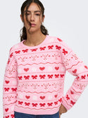 Close-up of pink ONLY Snowie jumper showing crew neckline and festive pattern
