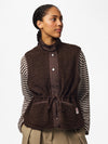 Model wearing PIECES Katty Hot Fudge teddy gilet with striped top and adjustable drawstring waist

