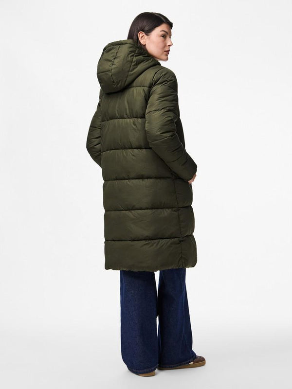Person wearing a long green puffer coat on a white background